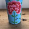 light blue tumbler with flower