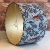 * pale blue tiger peacock lampshade with gold lining